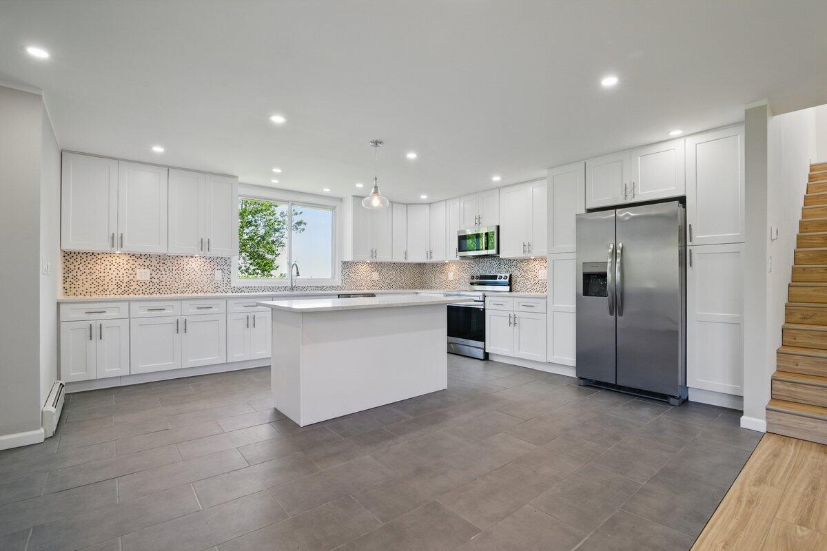 1652 Bonser Road Saylorsburg, PA 18353 - Photo 6 of 62 a kitchen with stainless steel appliances granite countertop a refrigerator sink and cabinets