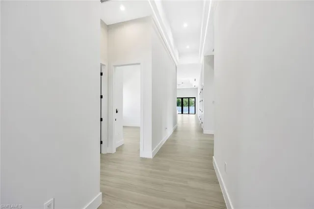 a view of a hallway with wooden floor
