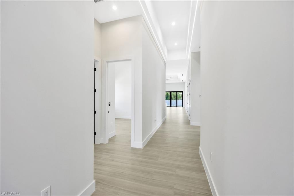 1297 Trail Terrace Drive Naples, FL 34103 - Photo 3 of 29 a view of a hallway with wooden floor