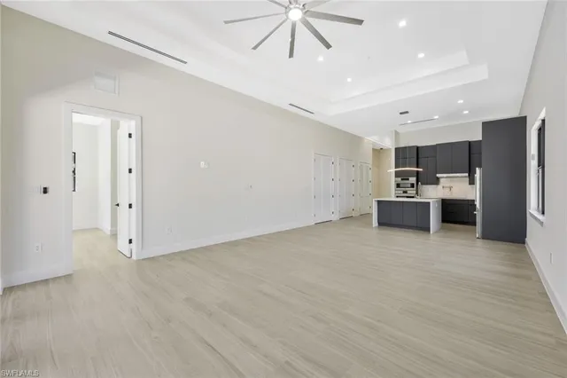 a view of kitchen with refrigerator and microwave