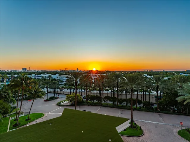 a view of a garden with a house in the background