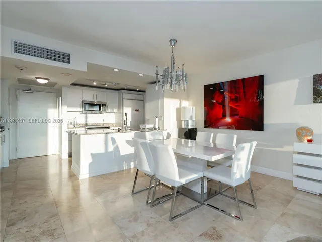 a view of a dining room kitchen with furniture and a chandelier
