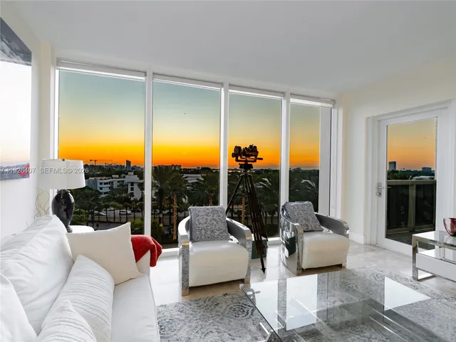 a living room with furniture lamp and a large window