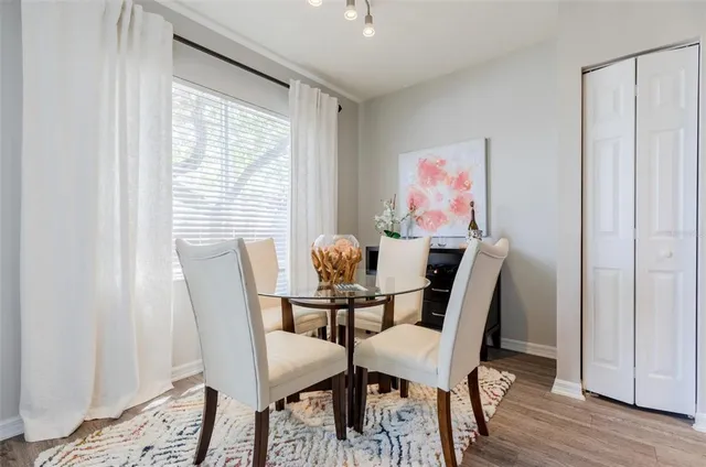 a view of a dining room with furniture and wooden floor