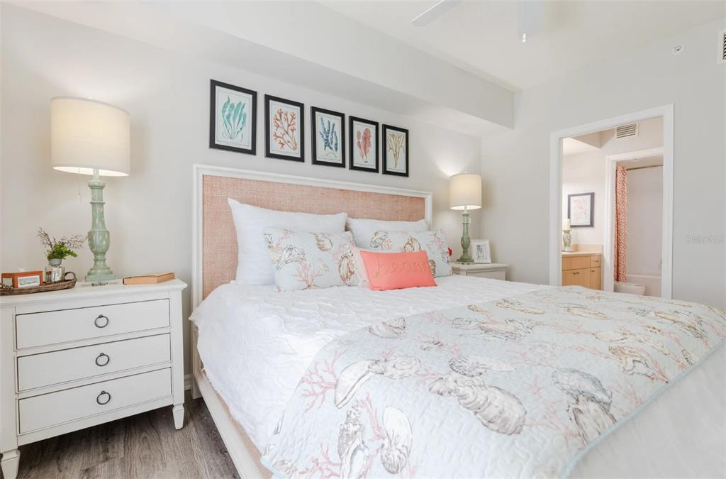 1010 Northwest Fresco Way, Unit 3B05303 Stuart, FL 34994 - Photo 13 of 47 a bedroom with a bed a lamp and a window