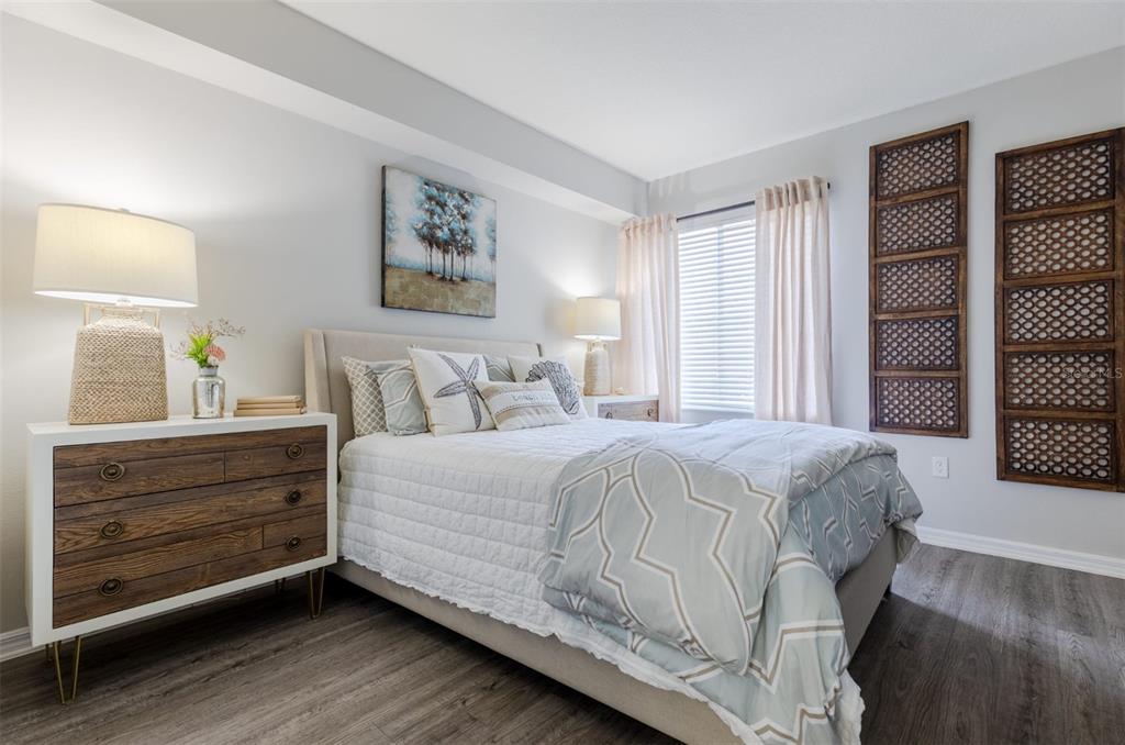 1010 Northwest Fresco Way, Unit 3B05303 Stuart, FL 34994 - Photo 16 of 47 a bedroom with a bed and a large window