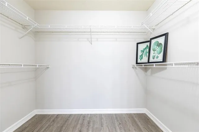 a view of room with window and wooden floor