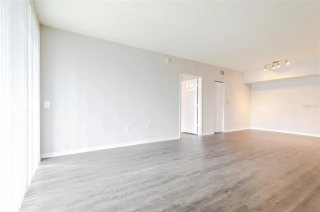 a view of an empty room and wooden floor