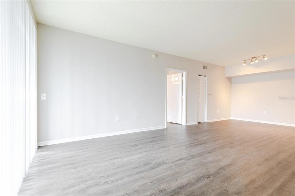 1010 Northwest Fresco Way, Unit 3B05303 Stuart, FL 34994 - Photo 21 of 47 a view of an empty room and wooden floor