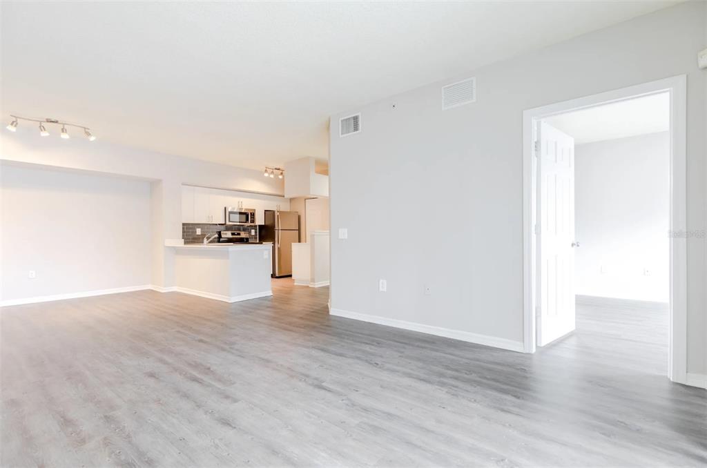 1010 Northwest Fresco Way, Unit 3B05303 Stuart, FL 34994 - Photo 24 of 47 a view of a kitchen with wooden floor and a refrigerator