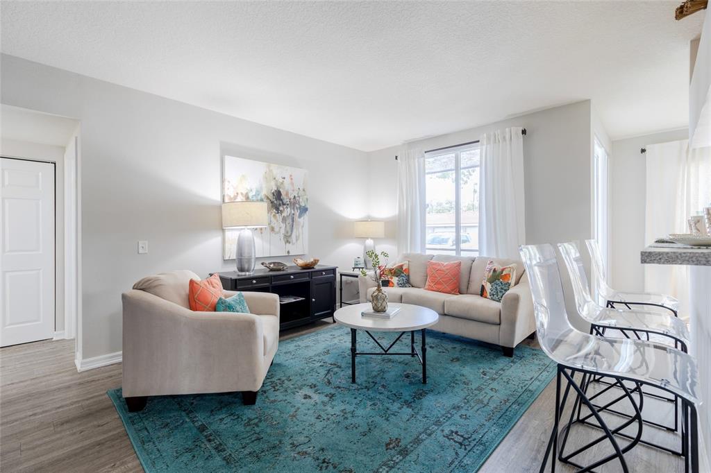 1010 Northwest Fresco Way, Unit 3B05303 Stuart, FL 34994 - Photo 3 of 47 a living room with furniture and a large window