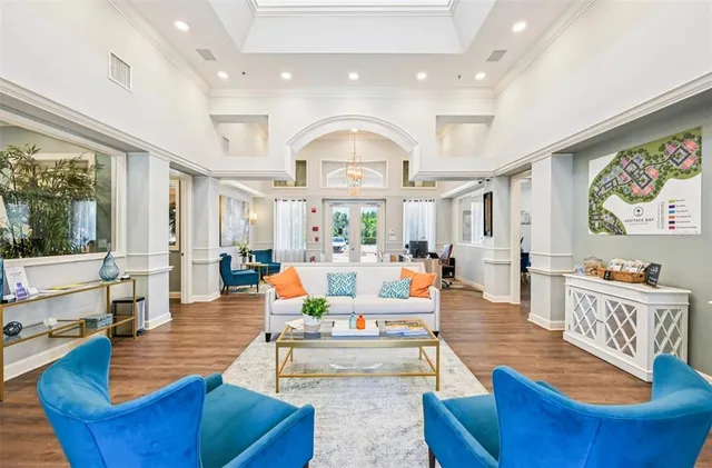 a living room with fireplace furniture and a large window