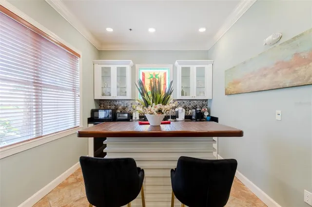 a view of kitchen with kitchen island stainless steel appliances sink refrigerator table and chairs