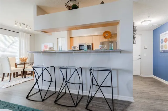 a group of chairs sitting in a kitchen and chandelier