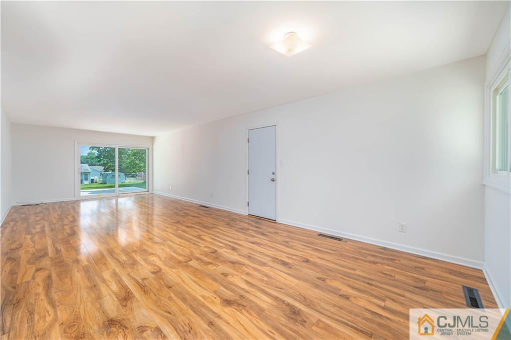 15 Pelham Road Kendall Park, NJ 08824 - Photo 12 of 26 a view of empty room with wooden floor and fan