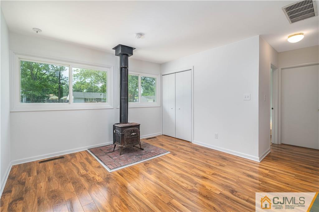 15 Pelham Road Kendall Park, NJ 08824 - Photo 15 of 26 a view of empty room with wooden floor and fan