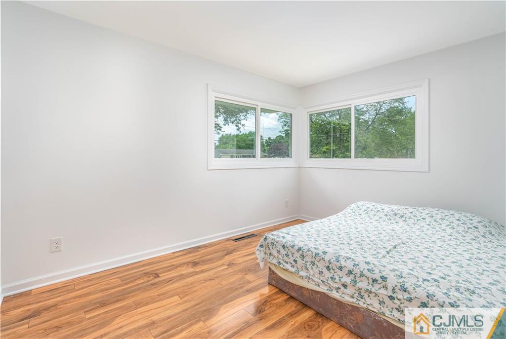 15 Pelham Road Kendall Park, NJ 08824 - Photo 19 of 26 a bedroom with a bed and a window