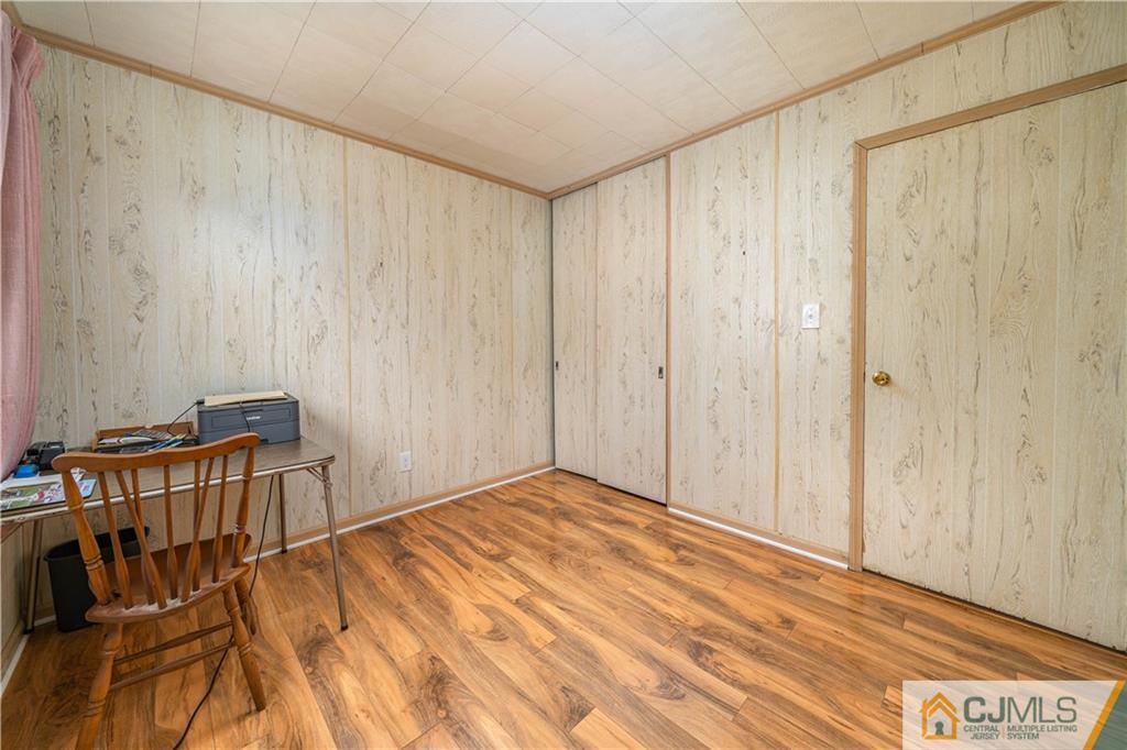 15 Pelham Road Kendall Park, NJ 08824 - Photo 20 of 26 a view of a bedroom with wooden floor and walls