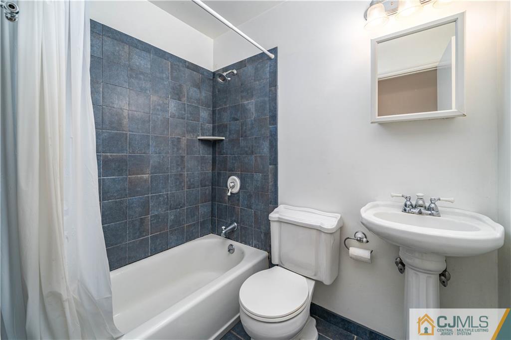 15 Pelham Road Kendall Park, NJ 08824 - Photo 21 of 26 a bathroom with a sink toilet and shower
