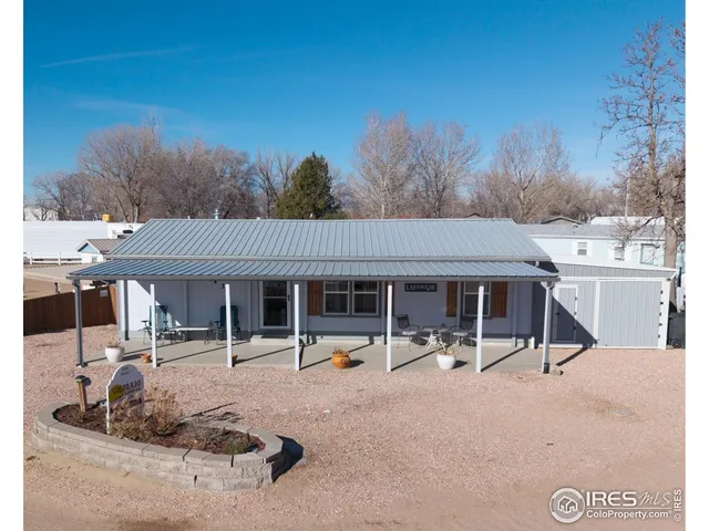 a living room with furniture and a ceiling fan