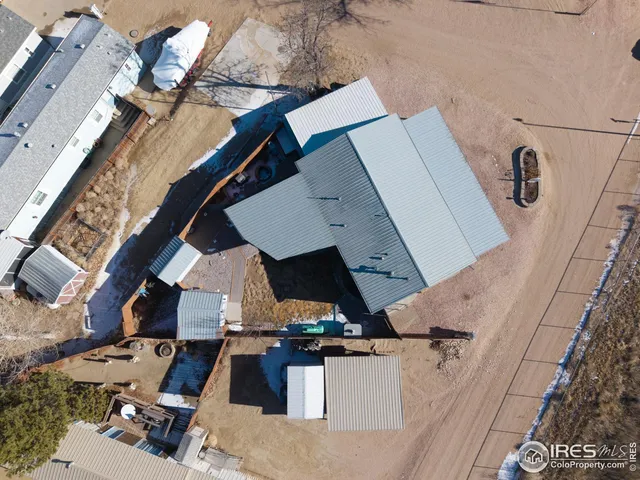 a living room with furniture a flat screen tv and floor to ceiling window