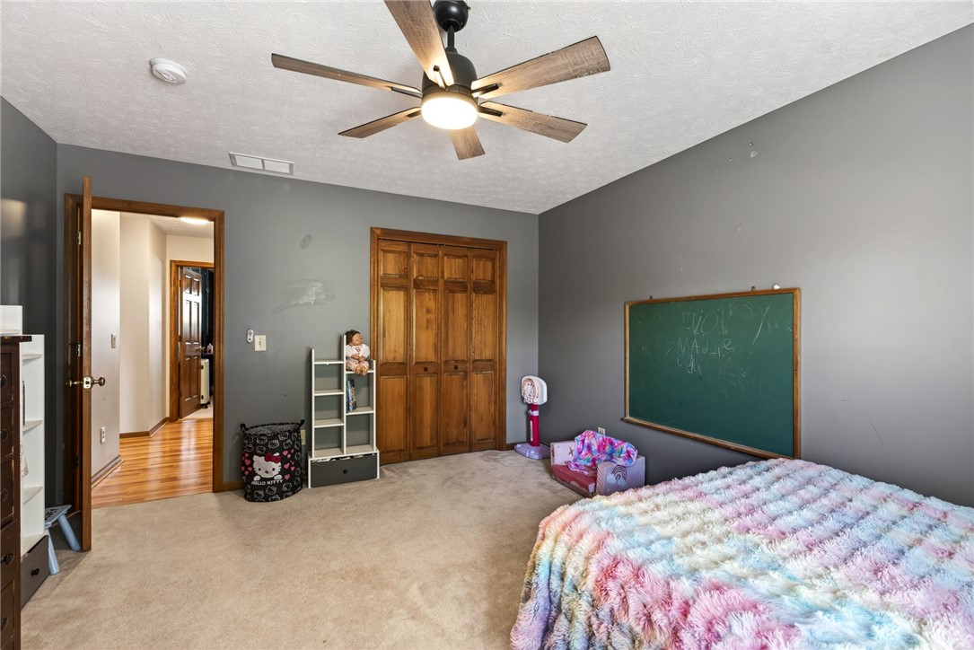 4996 Shannon Avenue Springfield, OH 45504 - Photo 43 of 61 This spacious room offers comfort and style with neutral carpeting and a modern ceiling fan.