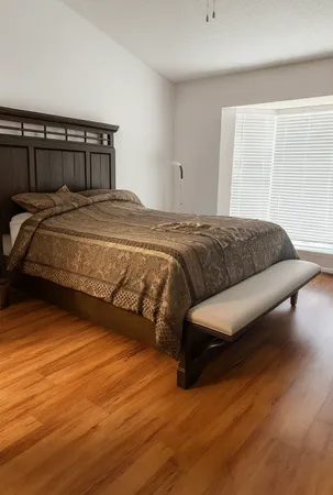 a bedroom with a bed and a night stand