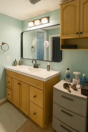 a bathroom with a double vanity sink and a mirror