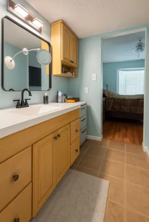 a en suite bathroom with a double vanity sink a mirror and a