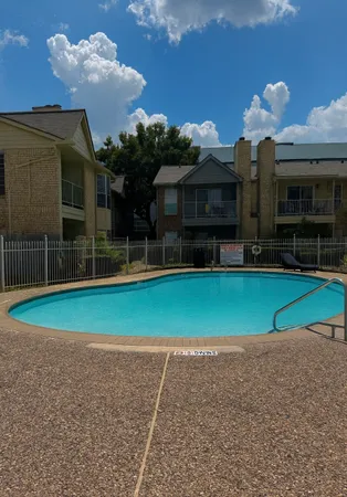 a view of a house with a swimming pool and a yard