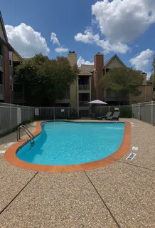 a view of a swimming pool with a yard