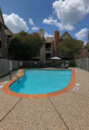 a view of a swimming pool with a yard