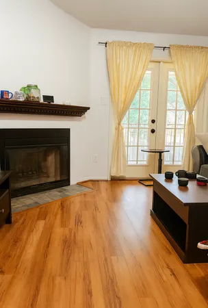 a living room with a fireplace furniture and a large window