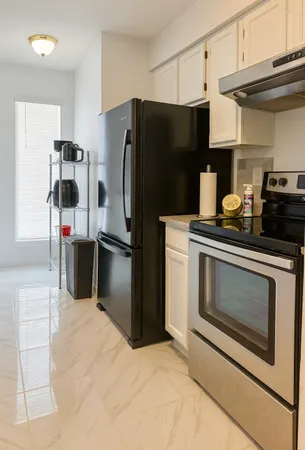 a kitchen with a refrigerator stove and cabinets