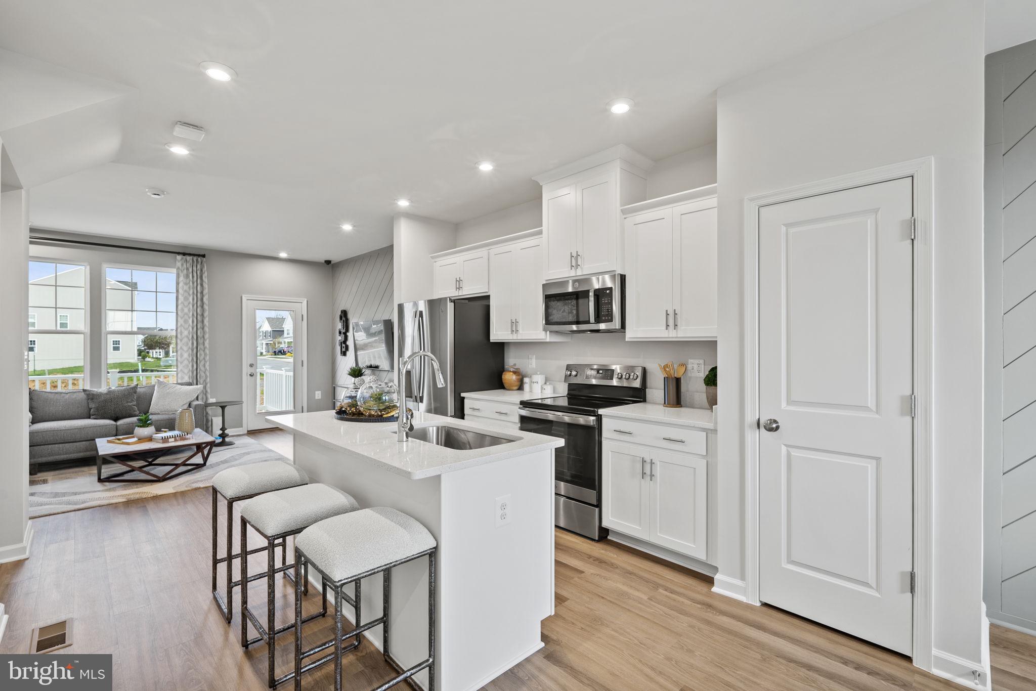 300 Presidents Pointe Avenue, Unit 609 Ranson, WV 25438 - Photo 78 of 87 a large white kitchen with stainless steel appliances