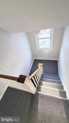 a view of a hallway with stairs
