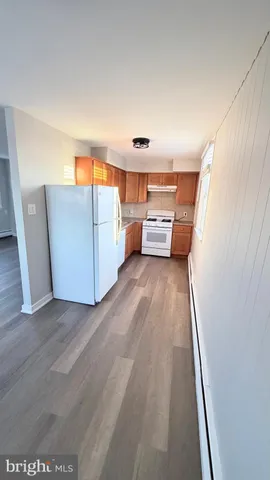 a view of a room with furniture and wooden floor