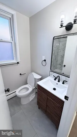 a bathroom with a sink a toilet and mirror