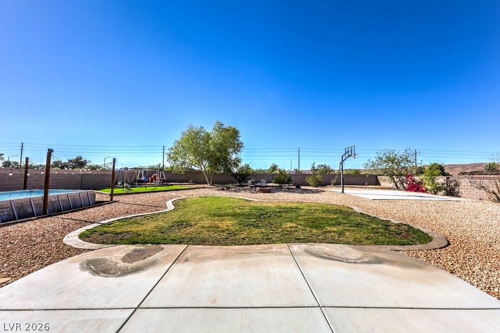1593 Valley Home Court Logandale, NV 89021 - Photo 38 of 57 Great backyard to entertain! Grass! Pool! Basketball court! Playground! And room to customize it to your desires!