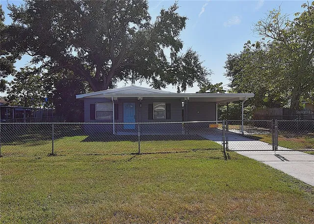 a view of a house with a backyard