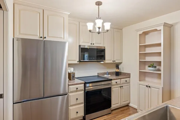 a kitchen with stainless steel appliances a refrigerator sink and cabinets
