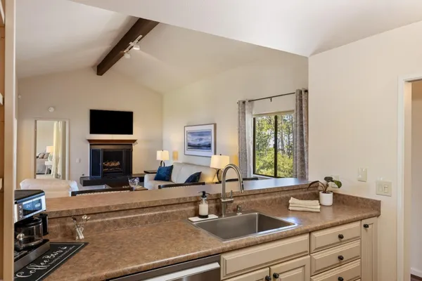 a view of a kitchen with a sink and a fireplace