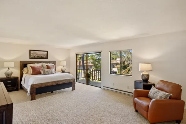 a spacious bedroom with a bed and a couch