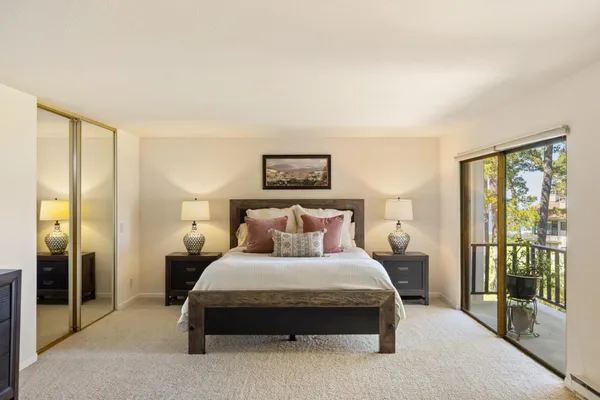 a bedroom with a large bed and a large window