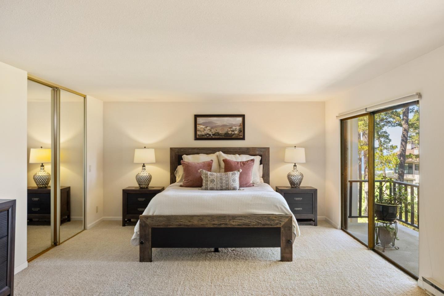 4 Ocean Pines Lane Pebble Beach, CA 93953 - Photo 16 of 49 a bedroom with a large bed and a large window