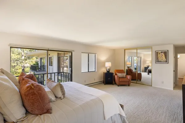 a bedroom with a bed and glass window