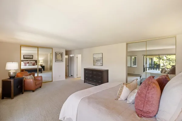 a spacious bedroom with a bed and furniture