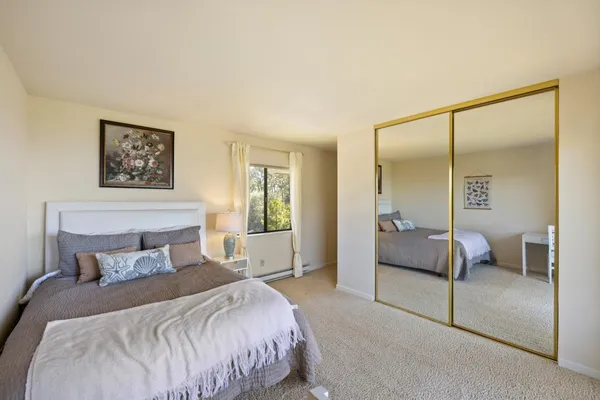 a bedroom with a bed and a mirror