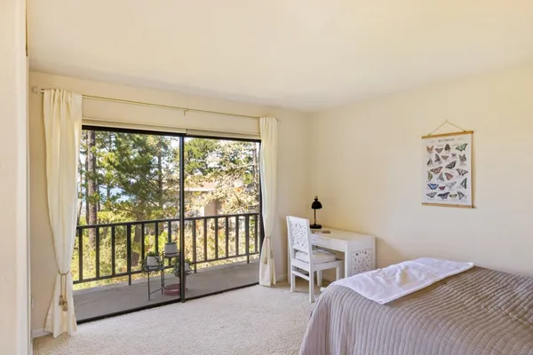a bedroom with a bed and a large window