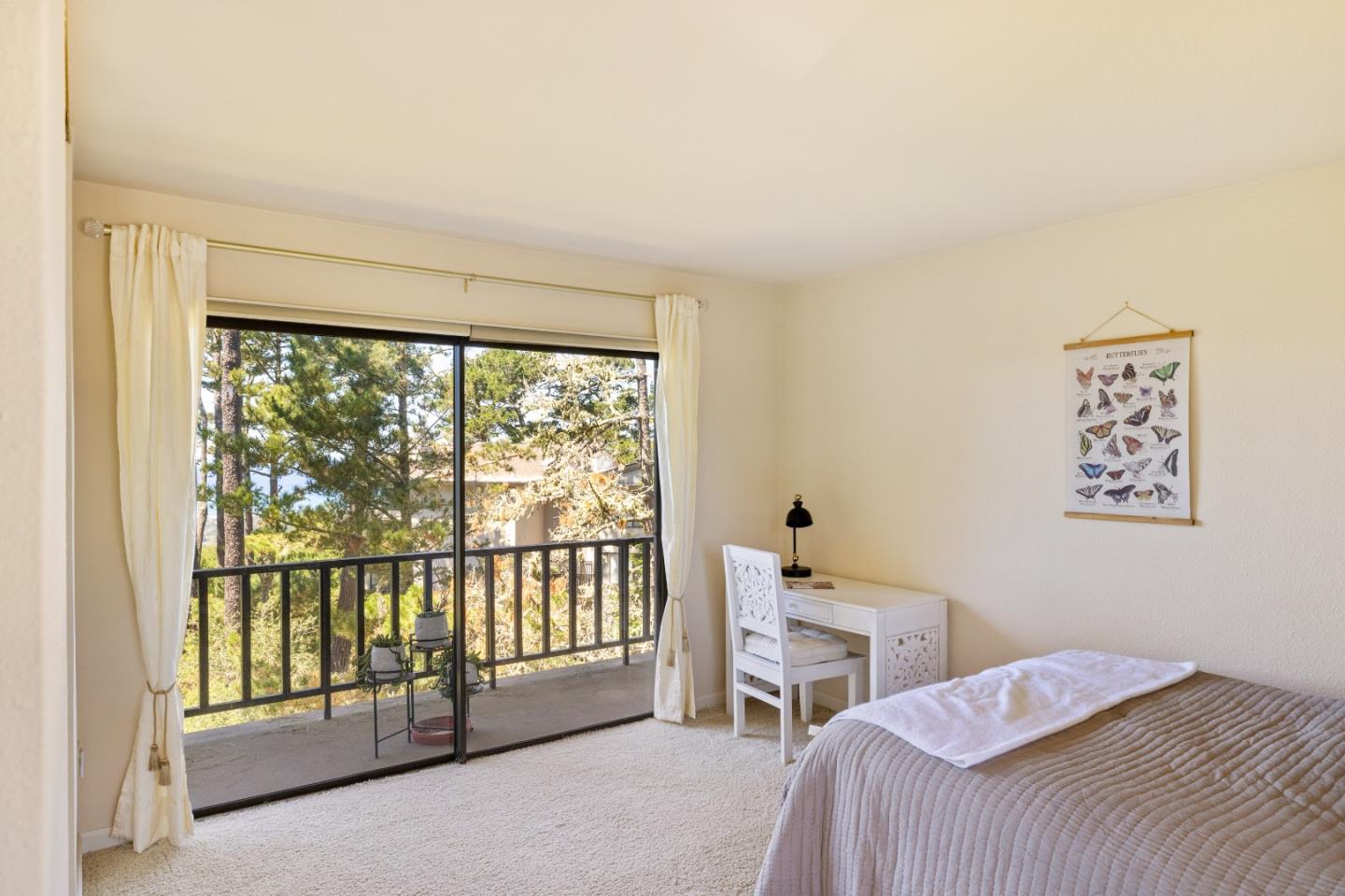 4 Ocean Pines Lane Pebble Beach, CA 93953 - Photo 25 of 49 a bedroom with a bed and a large window